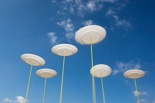 Showing multiple spinning plates on sticks like in a circus performance